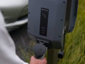 close up view of a person holding the ev charger